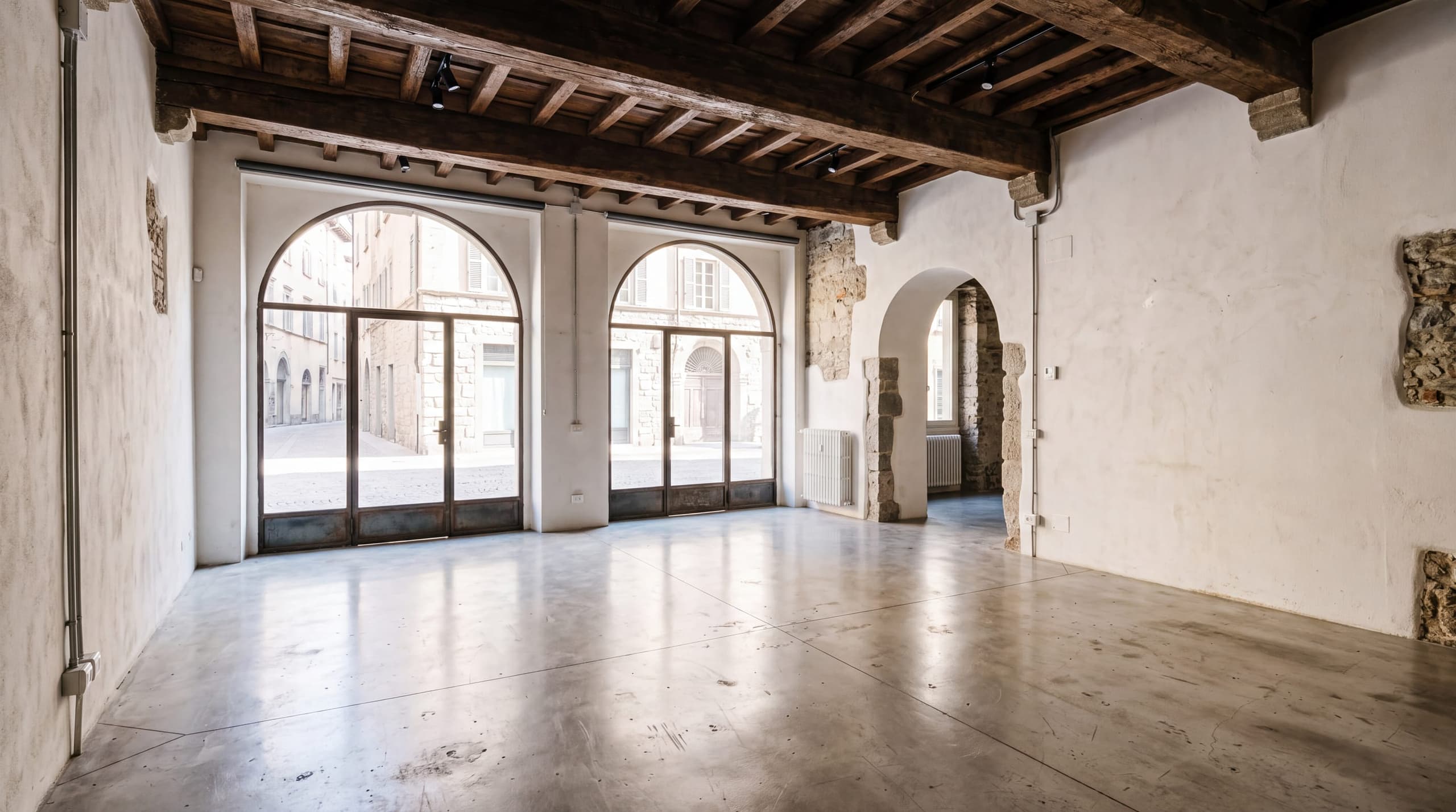 Spazio commerciale con vetrine ad arco in un palazzo storico